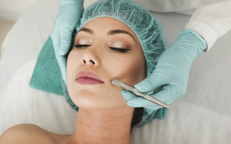 woman doing liposuction on her face
