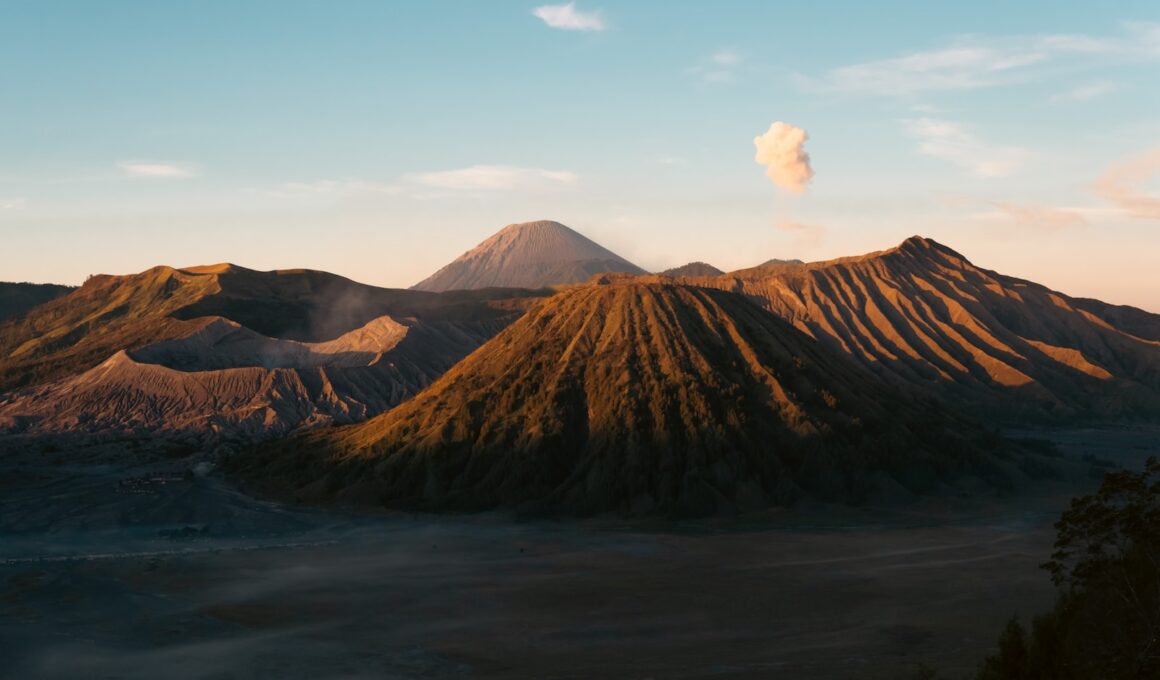 A view of a mountain with a cloud in the sky