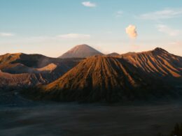 A view of a mountain with a cloud in the sky