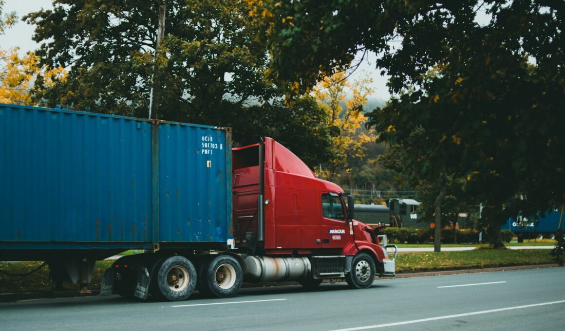 a red semi truck driving down a street