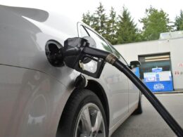 an electric car being charged at a gas station