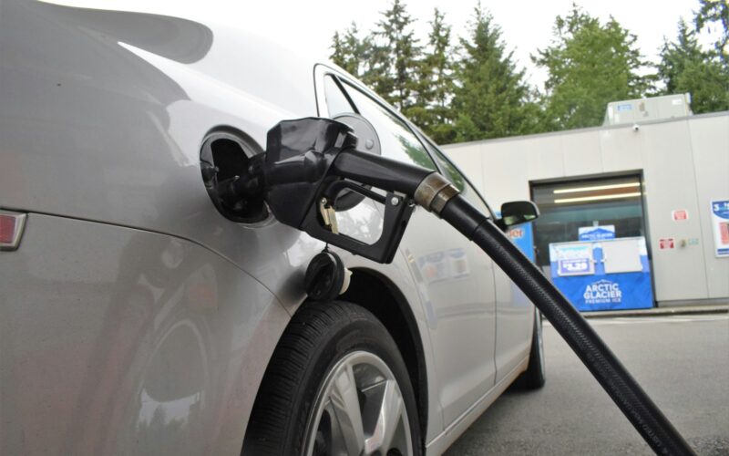 an electric car being charged at a gas station