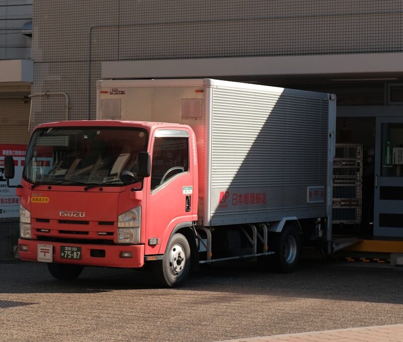 a red truck parked in front of a building