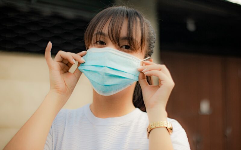 a woman wearing a face mask to protect herself from the sun