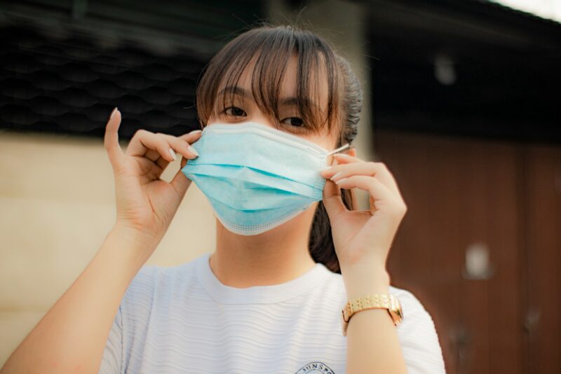 a woman wearing a face mask to protect herself from the sun