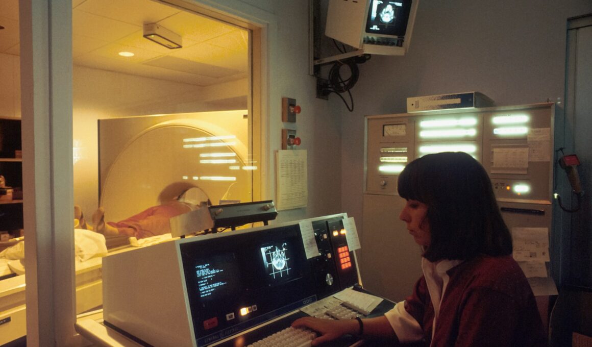 a woman sitting in front of a laptop computer