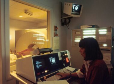 a woman sitting in front of a laptop computer