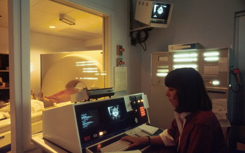 a woman sitting in front of a laptop computer