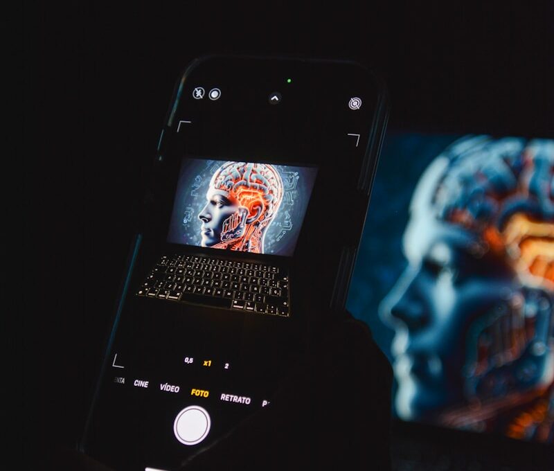 a cell phone sitting on top of a laptop computer