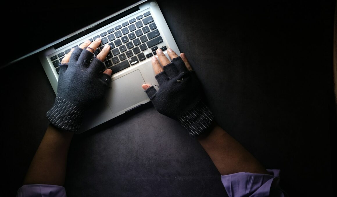 person in black long sleeve shirt using macbook pro