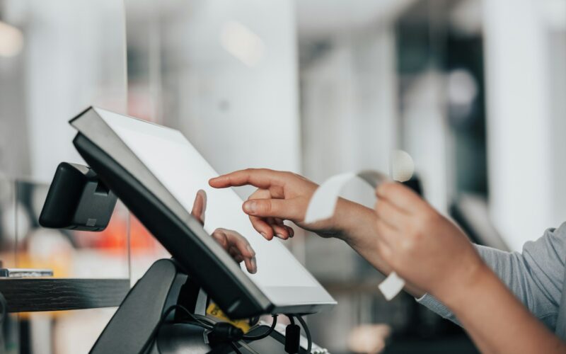 a person is using a pos machine in a store