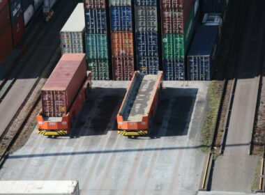 a train yard with cargo containers and train tracks