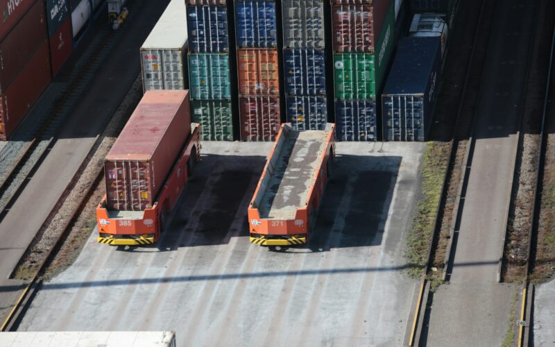 a train yard with cargo containers and train tracks