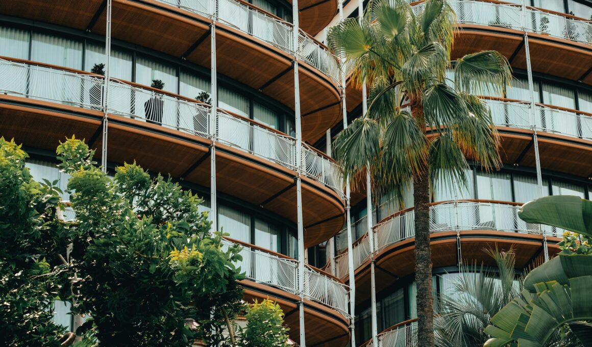 a tall building with balconies and palm trees in front of it