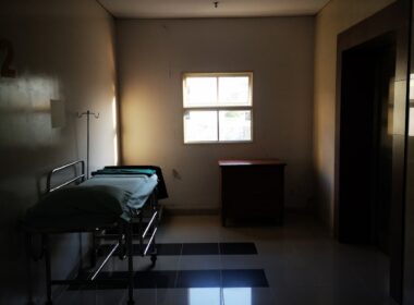 a dimly lit room with a hospital bed