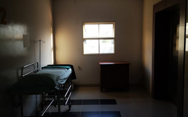 a dimly lit room with a hospital bed