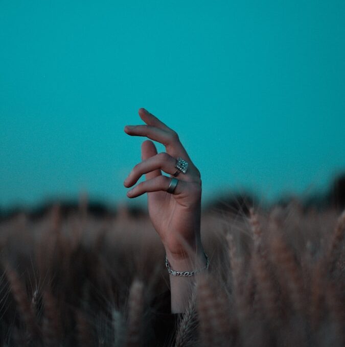 person wearing silver bracelet and bracelet