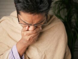 man in brown sweater wearing black framed eyeglasses