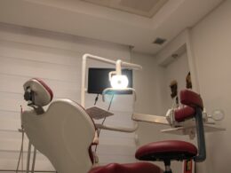 a dental room with a chair and a monitor