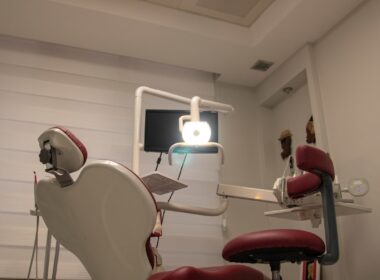 a dental room with a chair and a monitor