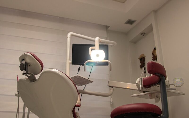 a dental room with a chair and a monitor