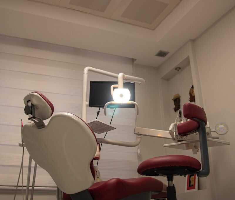 a dental room with a chair and a monitor