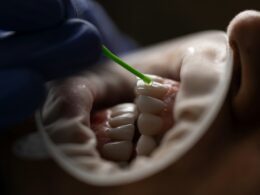 a person holding a green tube