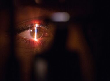 person with lighted cigarette in mouth