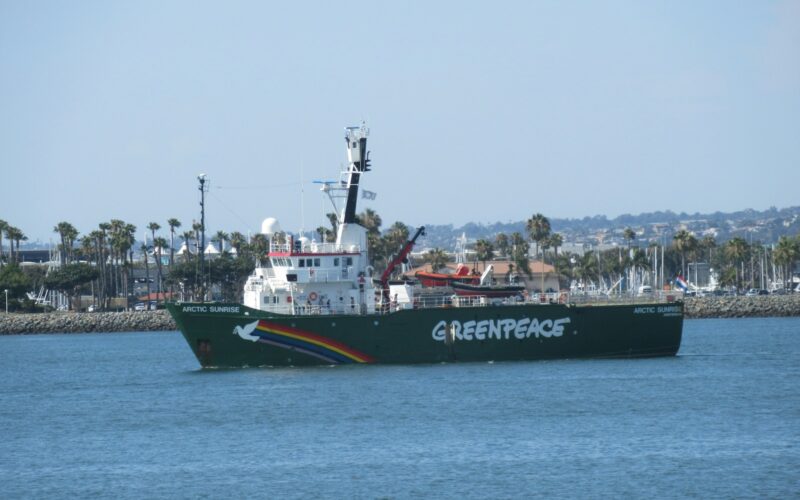 black and white ship on sea under white sky during daytime