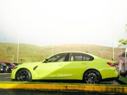 a yellow car is parked on the side of the road