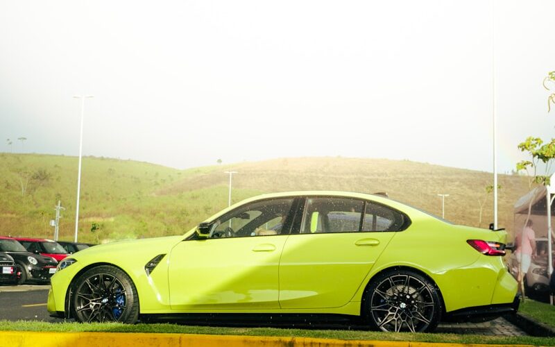 a yellow car is parked on the side of the road