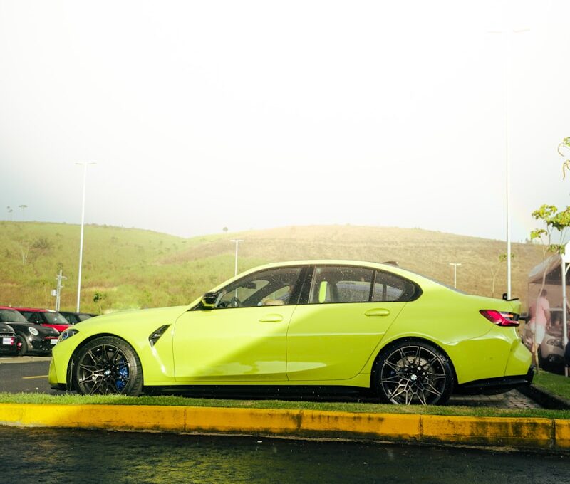 a yellow car is parked on the side of the road