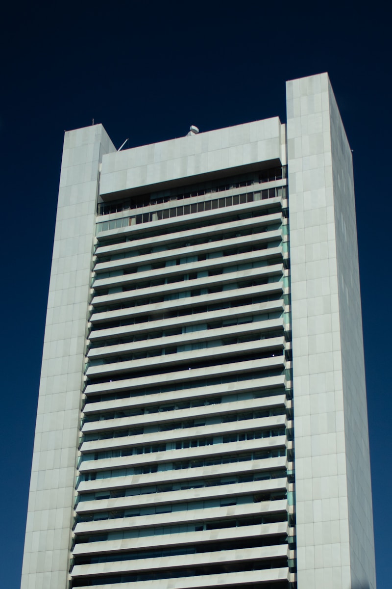 A tall building stands against a blue sky.