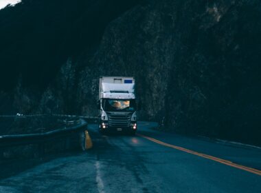 trailer truck passing on road near rail guard