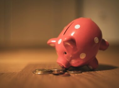 pink pig coin bank on brown wooden table