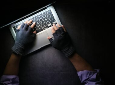 person in black long sleeve shirt using macbook pro