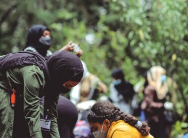 people in yellow jacket and black backpack