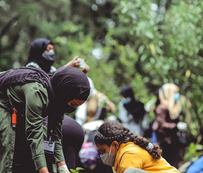 people in yellow jacket and black backpack