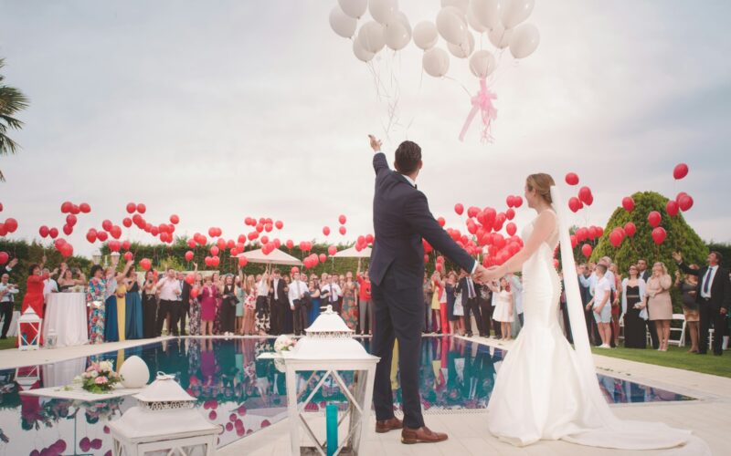 photo of a man and woman newly wedding holding a balloons