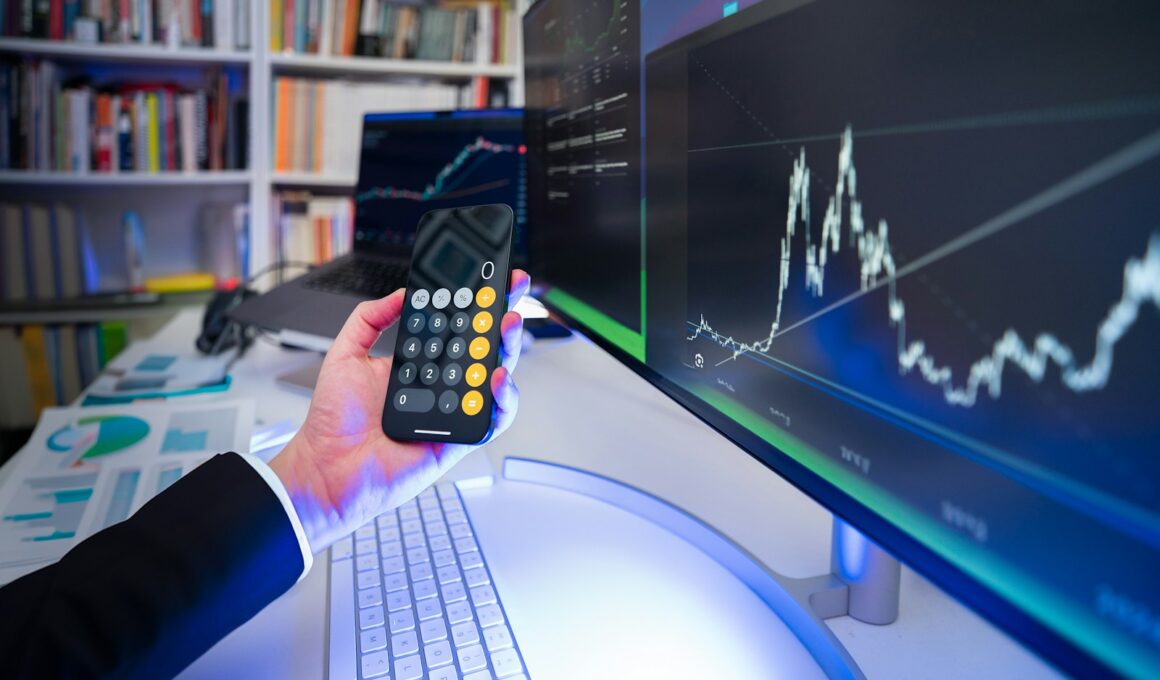 A man holding a remote control in front of a computer