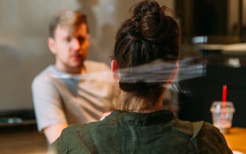 person sitting in a chair in front of a man