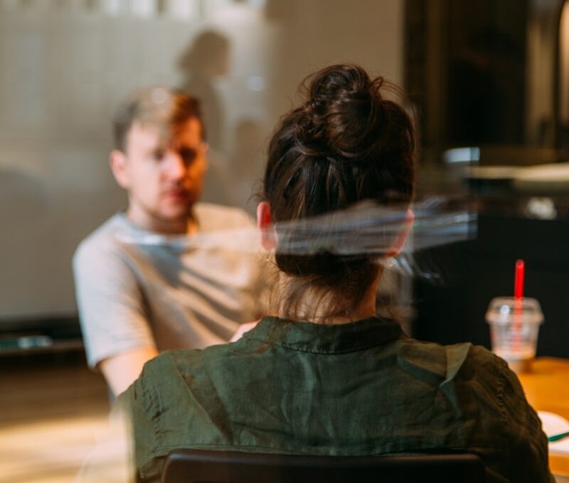 person sitting in a chair in front of a man