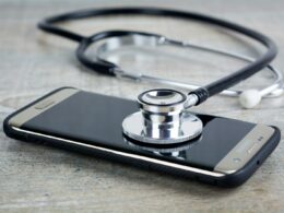 a smart phone with a stethoscope on top of it