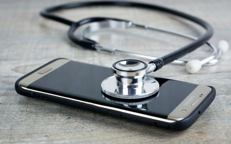 a smart phone with a stethoscope on top of it