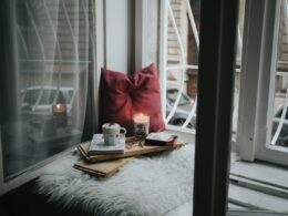 photo of gel candle on board beside pillow