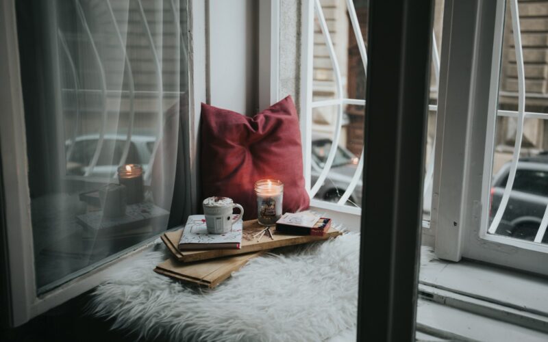 photo of gel candle on board beside pillow