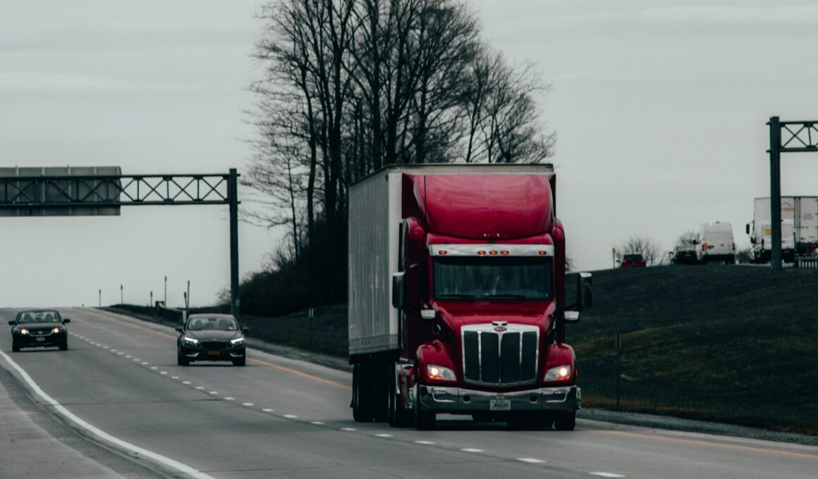 red and white truck on road during daytime