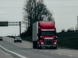 red and white truck on road during daytime
