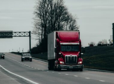 red and white truck on road during daytime