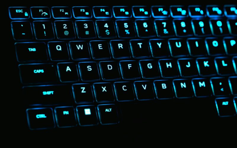 a close up of a keyboard with blue lights